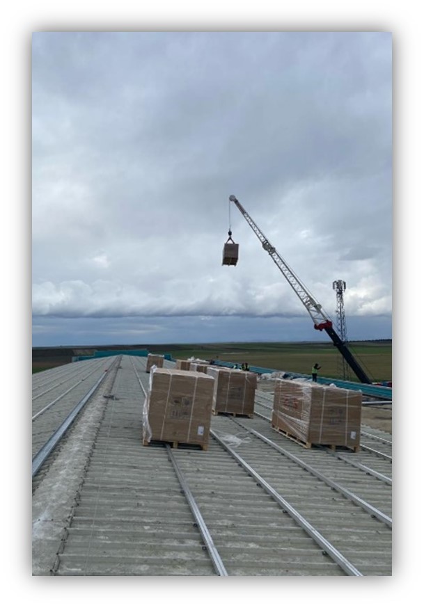 lifting operation of solar panels into roof of a factory